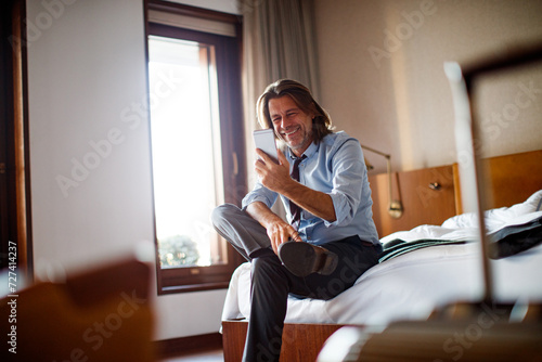 Middle aged businessman using a phone photo