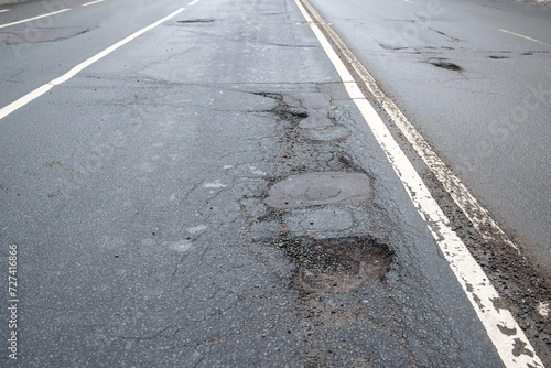 Obraz na płótnie Broken asphalt road in city and untimely repair