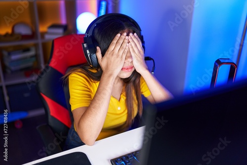 Young beautiful arab woman streamer stressed using computer at gaming room