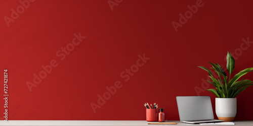 Workspace with red supplies, notebooks,plant and copy space. Home office desk.