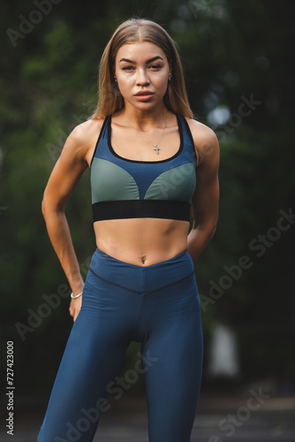 Fitness sport girl in fashion sportswear doing fitness exercise outdoor. Urban style 