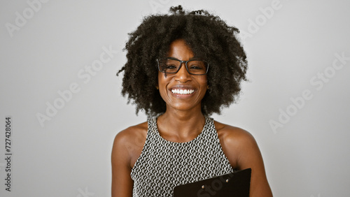African american woman business worker holding clipboard smiling over isolated white background photo