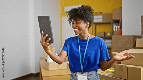 African american woman volunteer having video call by touchpad at charity center
