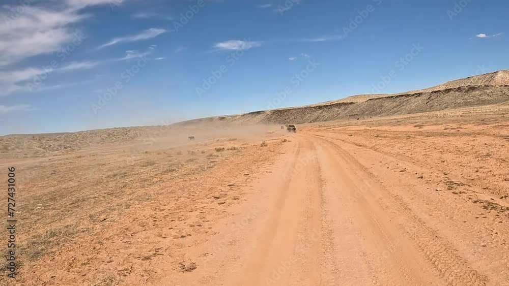 Off road recreation desert trail dusty Utah POV. Off road trail riding in 4x4 all terrain vehicle for sport recreation. Utah and Arizona landscape. Grass lands, rocky terrain and mountain valley. Off road recreation desert trail dusty Utah POV. Off road trail riding in 4x4 all terrain vehicle for sport recreation. Utah and Arizona landscape. Grass lands, rocky terrain and mountain valley.