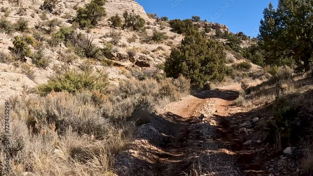 Off road recreation Utah desert trail valley POV. Off road trail riding in 4x4 all terrain vehicle for sport recreation. Utah and Arizona landscape. Grass lands, rocky terrain and mountain valley. Off road recreation Utah desert trail valley POV. Off road trail riding in 4x4 all terrain vehicle for sport recreation. Utah and Arizona landscape. Grass lands, rocky terrain and mountain valley.