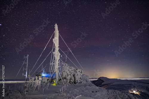 Ceahlau weather station in Romania. Night scene with stars in winter photo