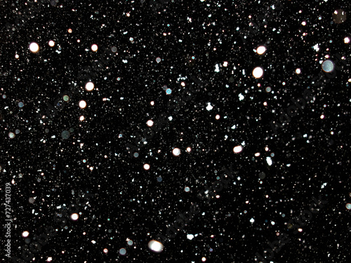 snow flakes at night, black background. snowing, taken with flash