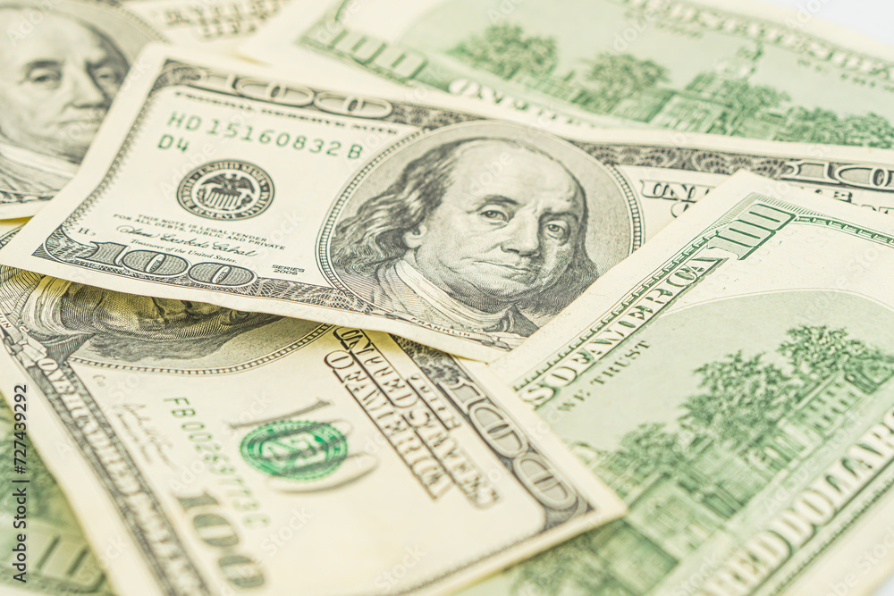 Lots of 100 dollar bills, the concept of US cash money. US paper money. Bribery with a wad of money, cash circulation and money exchange currency. Background of 100 dollar bills Lots of 100 dollar bills, the concept of US cash money. US paper money. Bribery with a wad of money, cash circulation and money exchange currency. Background of 100 dollar bills