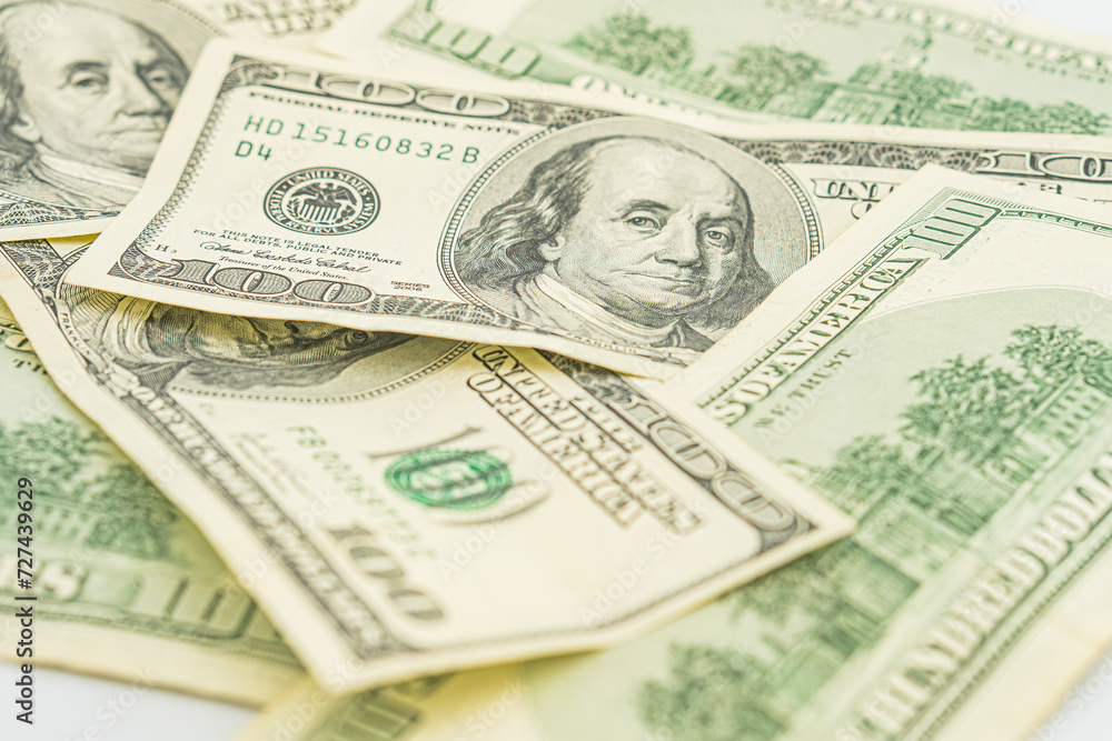 Lots of 100 dollar bills, the concept of US cash money. US paper money. Bribery with a wad of money, cash circulation and money exchange currency. Background of 100 dollar bills Lots of 100 dollar bills, the concept of US cash money. US paper money. Bribery with a wad of money, cash circulation and money exchange currency. Background of 100 dollar bills