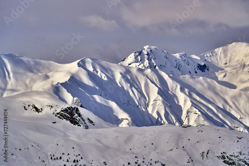 Breathtaking beautiful panoramic view on Snow Alps - snow-capped winter mountain peaks around French Alps mountains, The Three Valleys: Courchevel, Val Thorens, Meribel (Les Trois Vallees), France photo