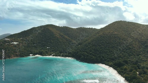 Flying towards gorgeous tropical mountains and beach turquoise water