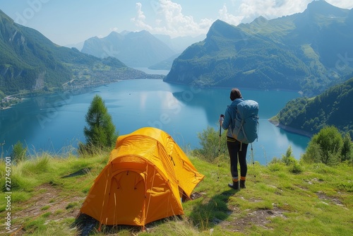 A lone adventurer seeks solace in the vast expanse of nature, their yellow tent a beacon of shelter against the towering mountains and endless sky, surrounded by the tranquil beauty of a grassy hill 