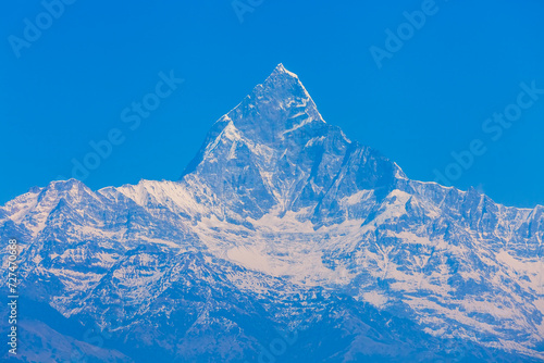 Panoramic view of the Himalayas from Sarangkot hill near Pokhara in Nepal.Colorful landscape of Nepal with winter blue sky.Snowcap mountain with space in panorama.Bright blue sky with snow in Nepal. photo