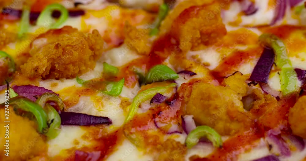 Fresh pizza with cheese and red onion with green pepper, large pieces of chicken meat on pizza Fresh pizza with cheese and red onion with green pepper, large pieces of chicken meat on pizza