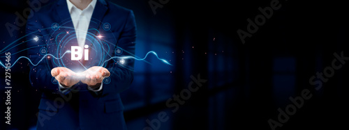 Businessman holding virtual Business Intelligence network connection icons. Data Analytics, Reporting, Insights for Internet business and social network. photo