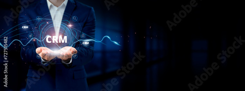 Businessman holding virtual Customer Relationship Management  CRM  network connection icons. Customer Engagement  Data Management  Relationship Building in Internet Business and Social Network.