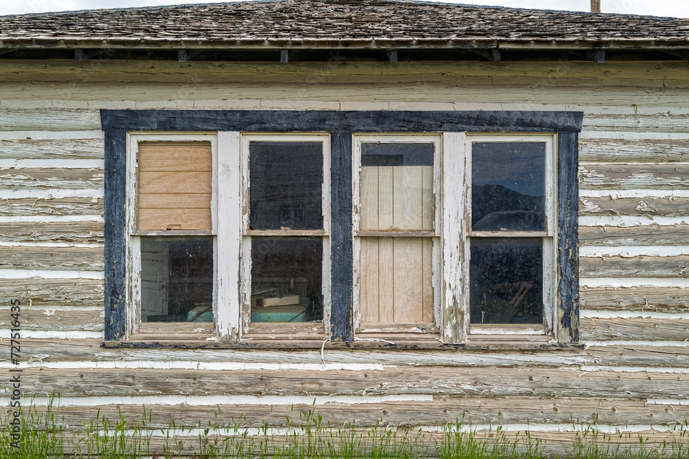 Windows on the exterior wall of an abandoned log building in southern Idaho, USA