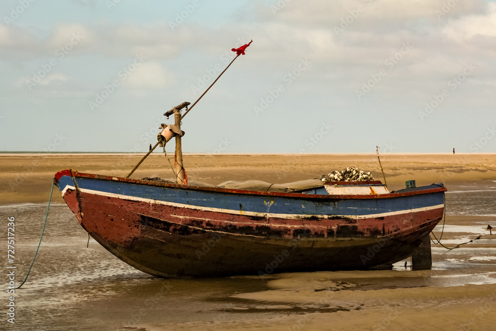 Photo of a rustic, traditional artisanal fishing boat in the state of Maranhão, Brazil, with the background blurred. Photo of a rustic, traditional artisanal fishing boat in the state of Maranhão, Brazil, with the background blurred.