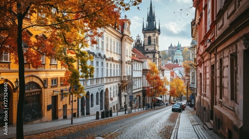 Autumn foliage with street and beautiful historical buildings of Prague city in Czech Republic in Europe.