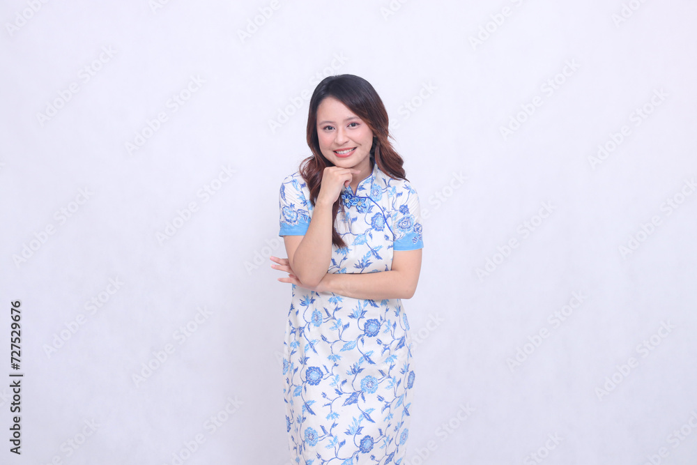 Beautiful smile asian woman wearing modern chinese dress arms crossed isolated on white background. happy Chinese New Year Beautiful smile asian woman wearing modern chinese dress arms crossed isolated on white background. happy Chinese New Year