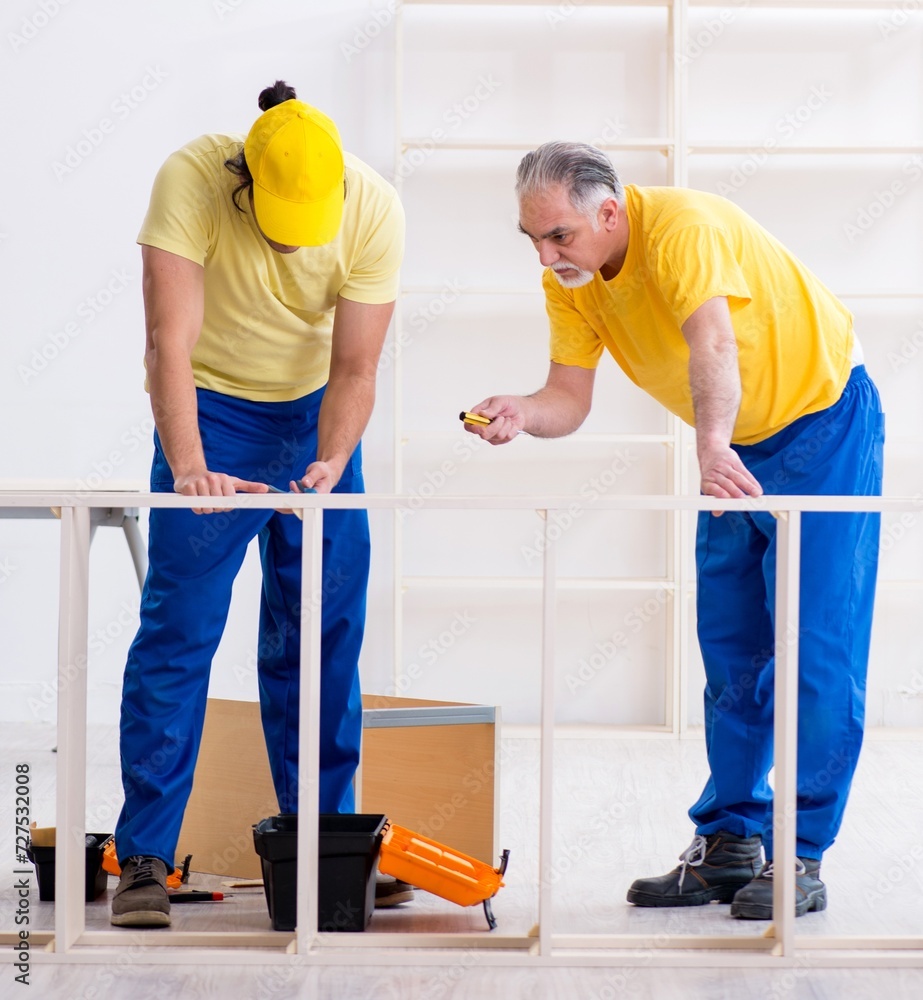 Two contractors carpenters working indoors Two contractors carpenters working indoors