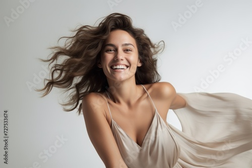 Woman in a flowing dress, radiant smile