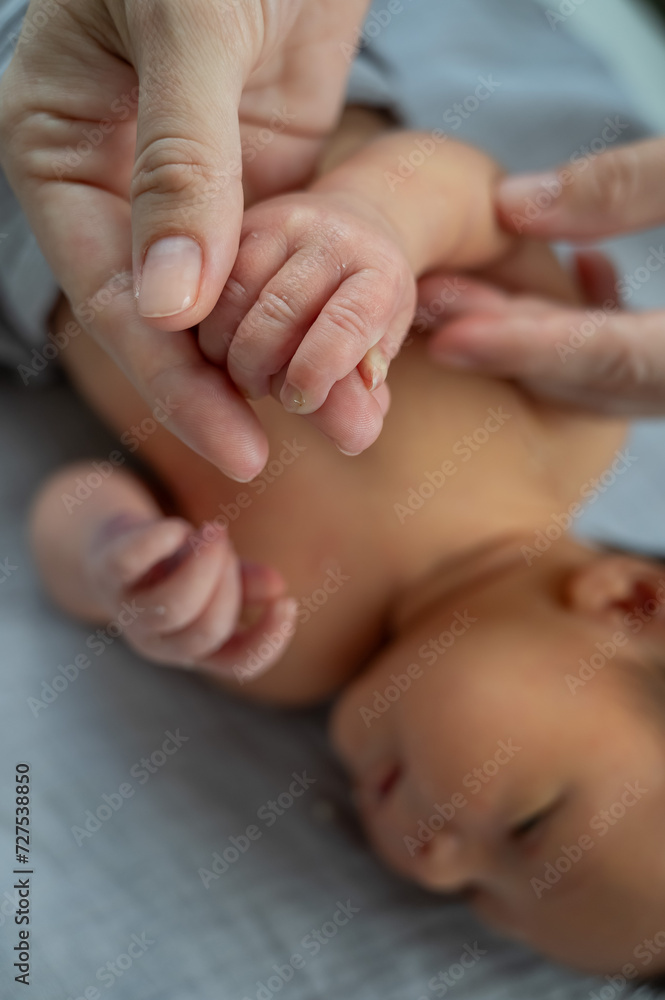 A newborn boy holds his mother's finger. Close-up of hands. A newborn boy holds his mother's finger. Close-up of hands.
