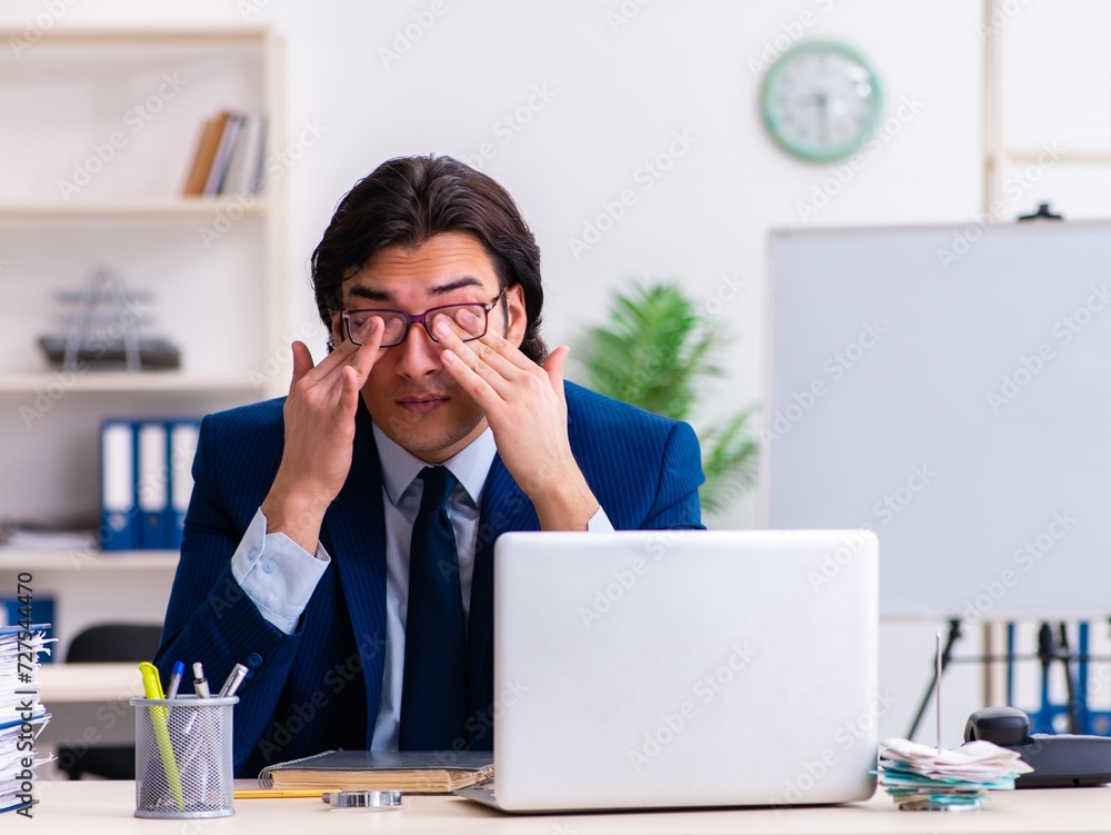 Young businessman sitting and working in the office Young businessman sitting and working in the office