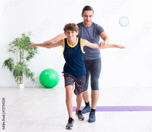 Young father and his son doing exercises