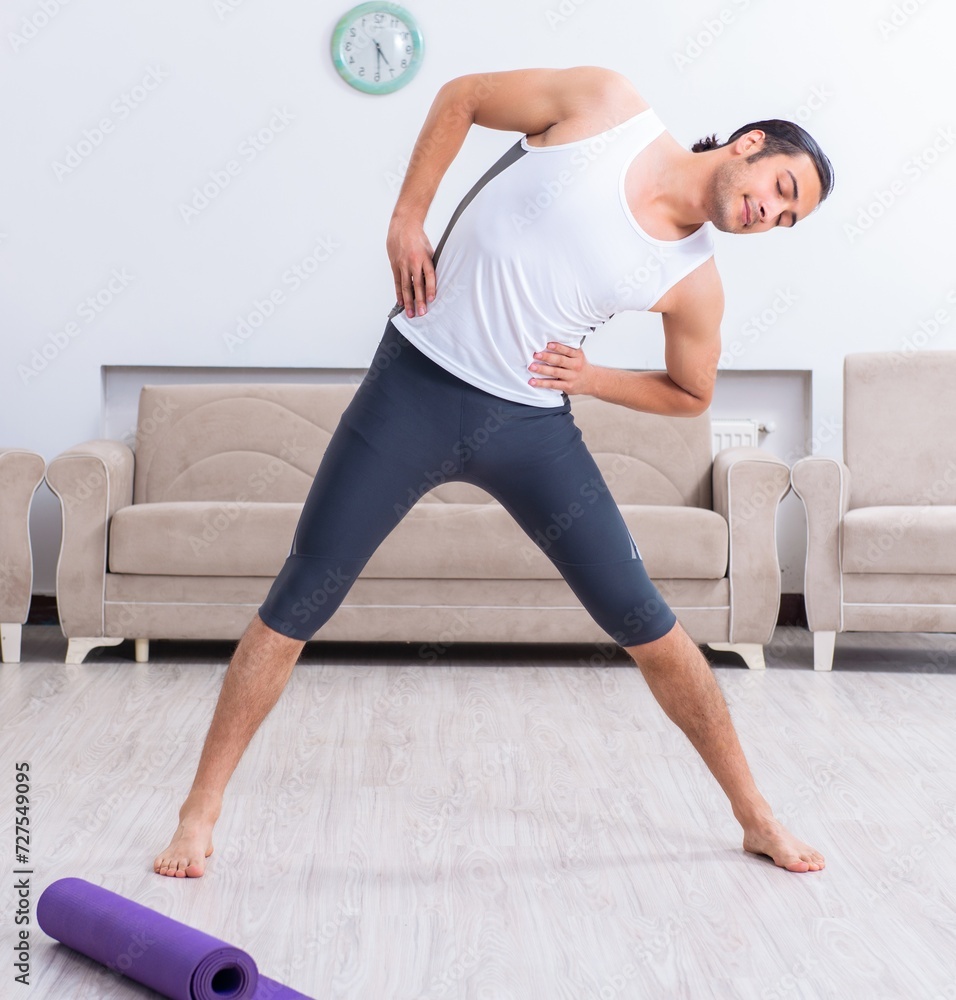 Young man training and exercising at home Young man training and exercising at home