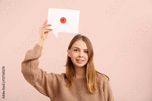 Pretty young woman holding ...