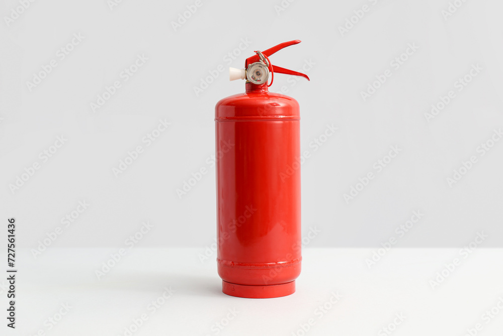 Fire extinguisher on grey background Fire extinguisher on grey background