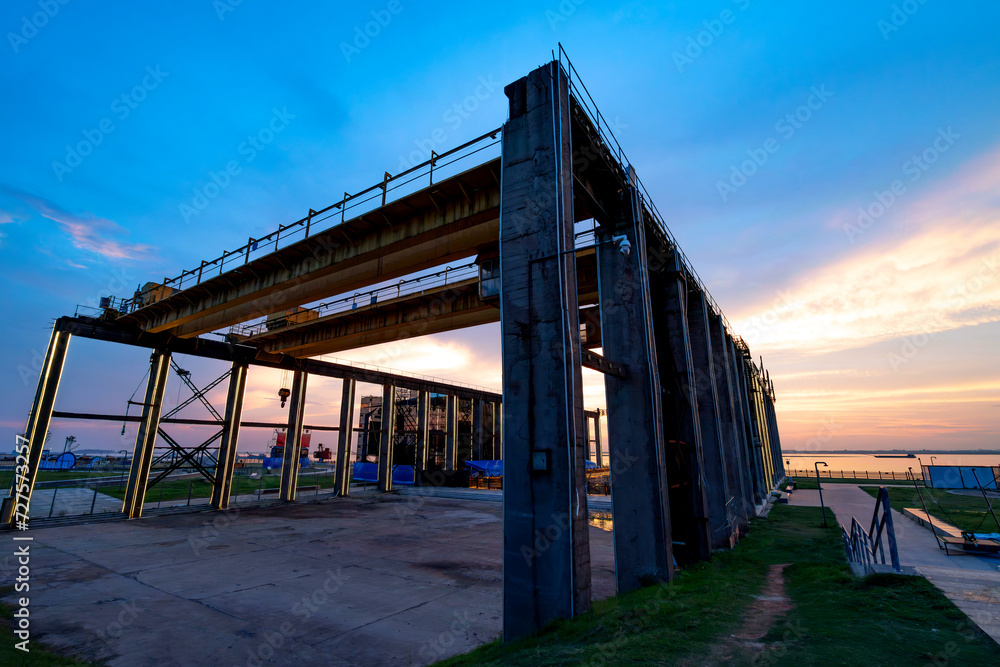 The steel structure and bridge crane of the dock are located by the Dongting Lake in Yueyang, China. The steel structure and bridge crane of the dock are located by the Dongting Lake in Yueyang, China.