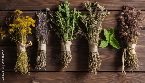 Four different herbs in small bags hanging on a wooden wall