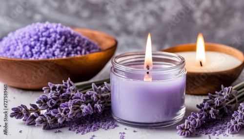 A purple candle and lavender flowers on a table