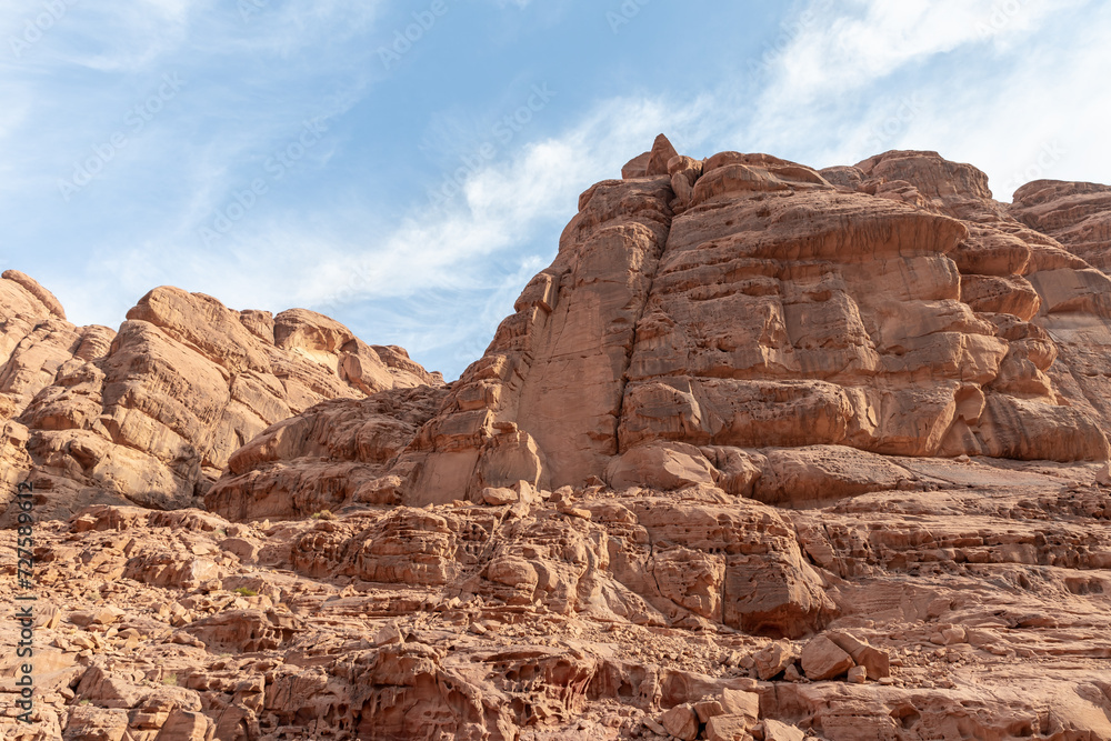Fototapeta premium Bizarre shapes of the high mountains in the red desert of the Wadi Rum near Amman in Jordan