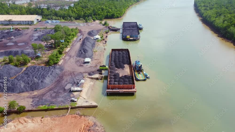 The process of loading coal onto barges using heavy transport cars The process of loading coal onto barges using heavy transport cars