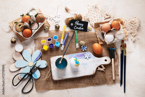 Easter DIY. Easter preparation, multi-colored paints and a brush for decorating eggs. Creativity with children.