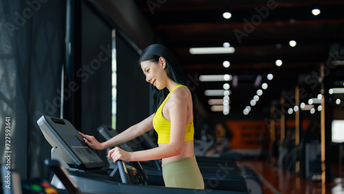 Young Asian Woman Running on Treadmill - Fitness Gym Exercise