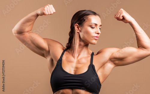 Fit Healthy Woman in Sportswear Flexing Bicep Muscles