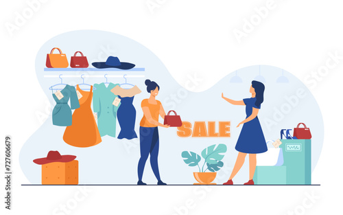 Female customer refusing to branded bag and choosing clothes in sale. Shop with dresses, hats, bags and shoes. Woman buying less luxury branded clothes. Fashion, sale, shopping concept