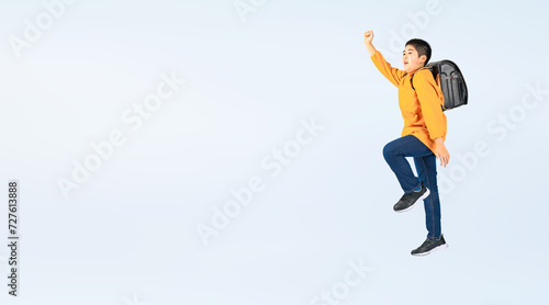 ジャンプするランドセルを背負ったの小学生の男の子（切り抜き背景透過PNGも販売しております。作成者リンクから「PNG」で検索してください） photo