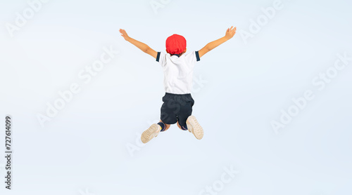 ジャンプする体操服を着た男の子の後ろ姿（切り抜き背景透過PNGも販売しております。作成者リンクから「PNG」で検索してください） © metamorworks
