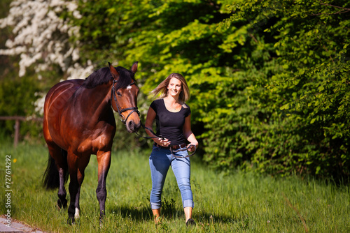 Young woman with horse in spring in nature. © RD-Fotografie