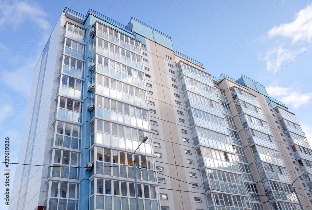 multi-storey residential buildings against a background of blue sky with clouds multi-storey residential buildings against a background of blue sky with clouds