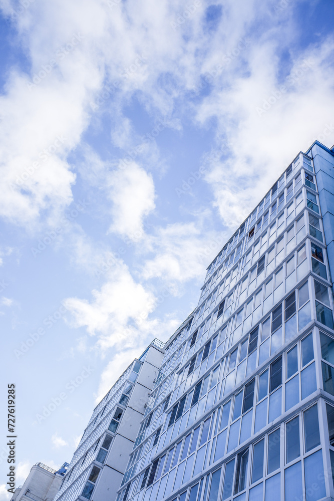 multi-storey residential buildings against a background of blue sky with clouds multi-storey residential buildings against a background of blue sky with clouds