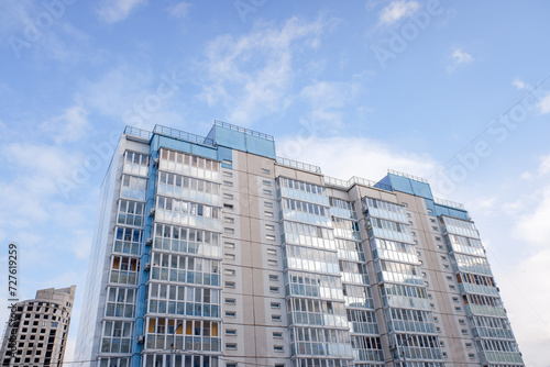multi-storey residential buildings against a background of blue sky with clouds