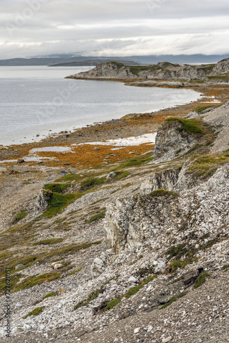Rocky shores of the Porsanger Fjord, Barents Sea, on a calm late summer evening, Finnmark, Norway
