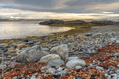 Rocky shores of the Porsanger Fjord, Barents Sea, on a calm late summer evening, Finnmark, Norway photo