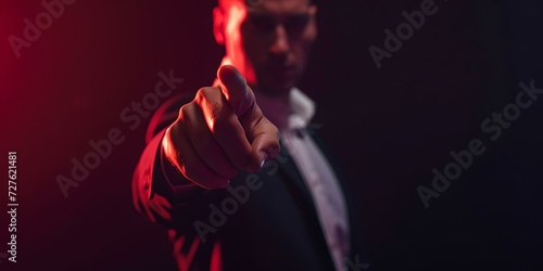 Mysterious man pointing forward in a dark room. business style attire with dramatic lighting. perfect for suspense themes. AI
